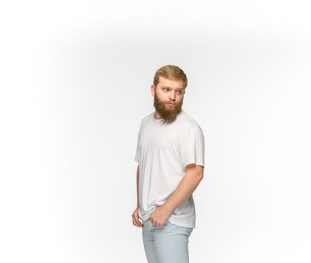 Closeup of young man's body in empty white t-shirt isolated on white background.