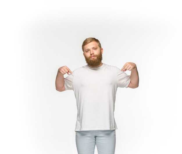 Closeup of young man's body in empty white t-shirt isolated on white