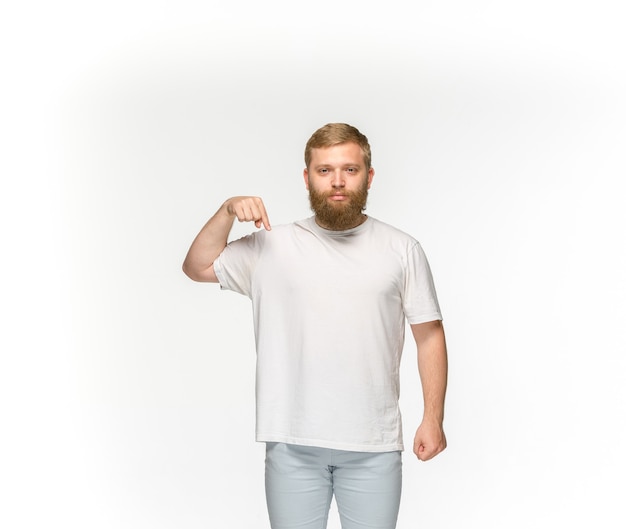 Closeup of young man's body in empty white t-shirt isolated on white.