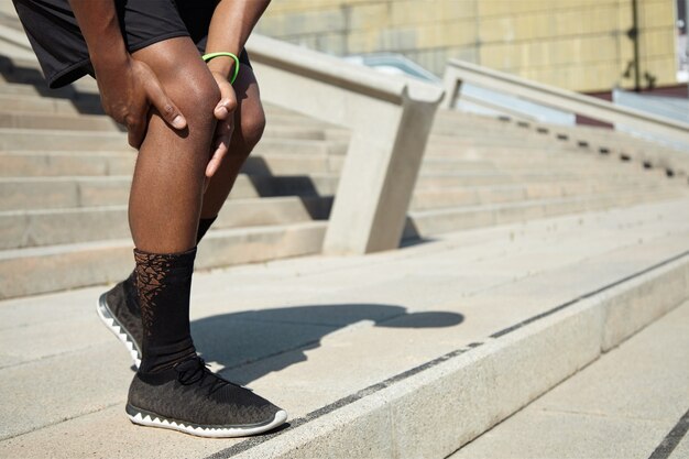 Closeup of young man with knee injury