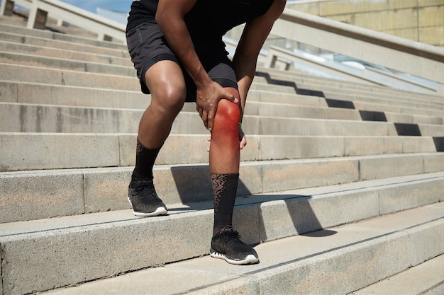 Closeup of young man with knee injury