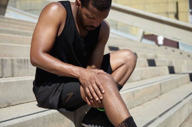 Closeup of young man with knee injury