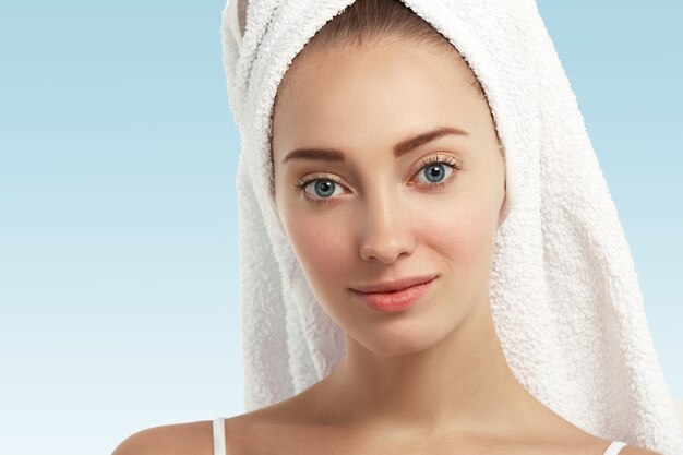 Closeup of young woman with towel on head