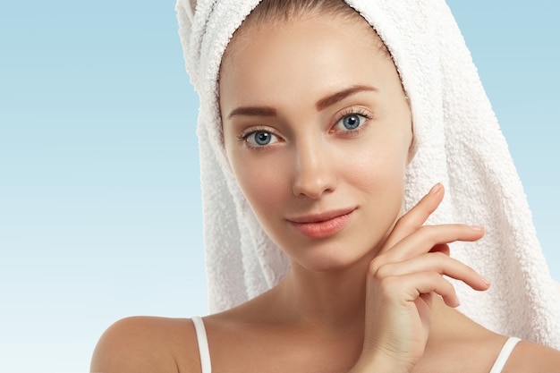 Closeup of young woman with towel on head