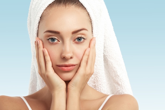 Closeup of young woman with towel on head