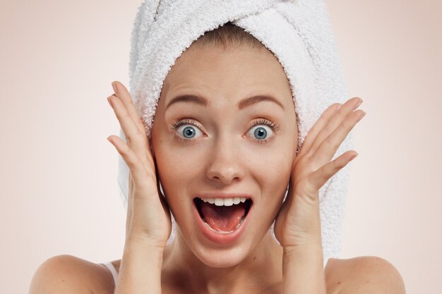 Closeup of young woman with towel on head