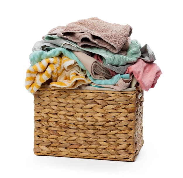 Clothes in a laundry wooden basket isolated on white background