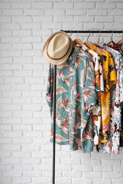 Clothing rack with hawaiian shirts with floral print and hat