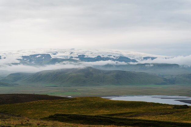 Cloudy nature landscape by lake