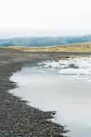 Free photo cloudy nature landscape by lake