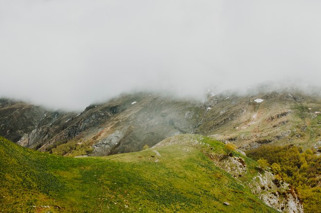 Cloudy rocky landscape with vegetation