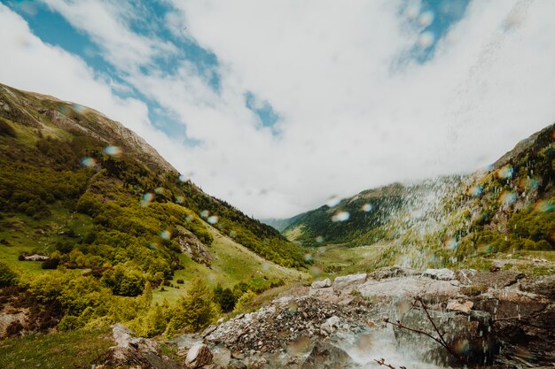 Cloudy rocky landscape with vegetation