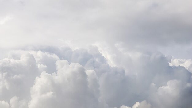 Cloudy sky background sunlight shining through the white clouds