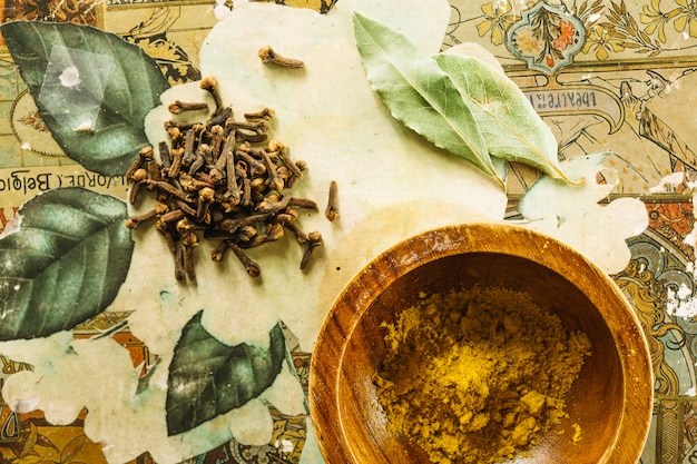 Cloves and bay leaves lying near turmeric