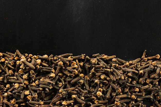 Free photo cloves on black background