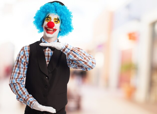 Clown indicating a measure with hands