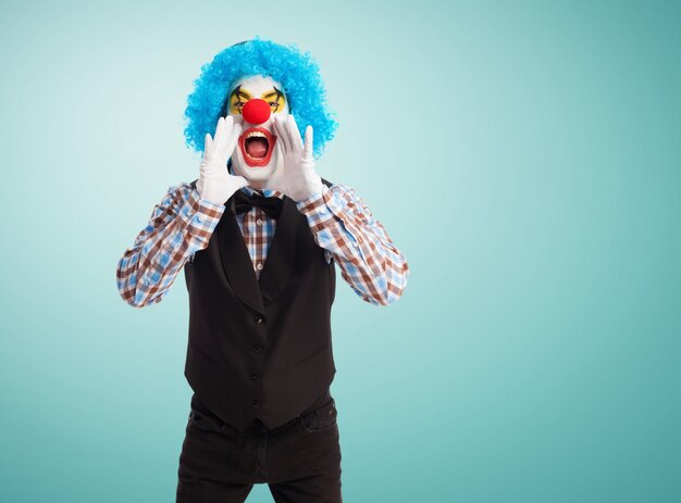 Clown screaming with hands in mouth
