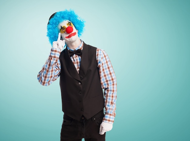 Free photo clown with a finger in the eye