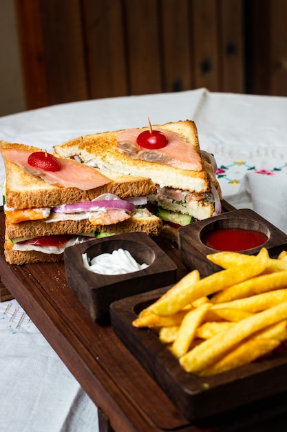 Foto gratuita panino al salmone e patatine fritte