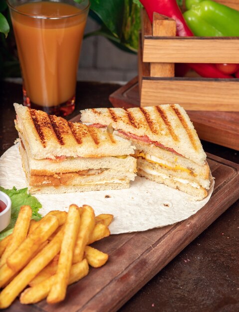 Club sandwich served with french fries and soft drink, mayonnaise, ketchup 