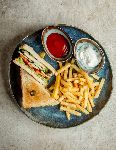 Club sandwich with french fries _