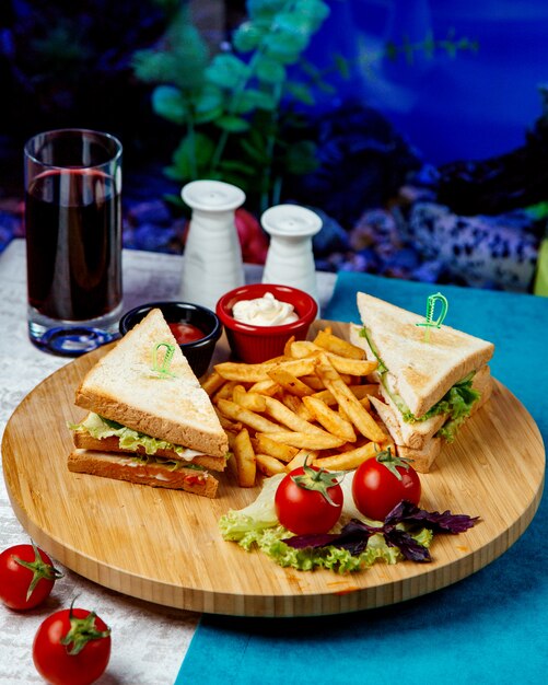 Club sandwich with fries and tomatoes