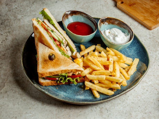 Club sandwich with fries