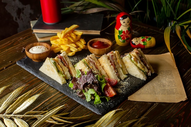 Club sandwiches served with french fries ketchup and mayonnaise
