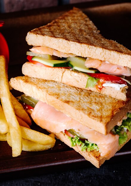 Club sandwiches with toast, ham and vegetables.
