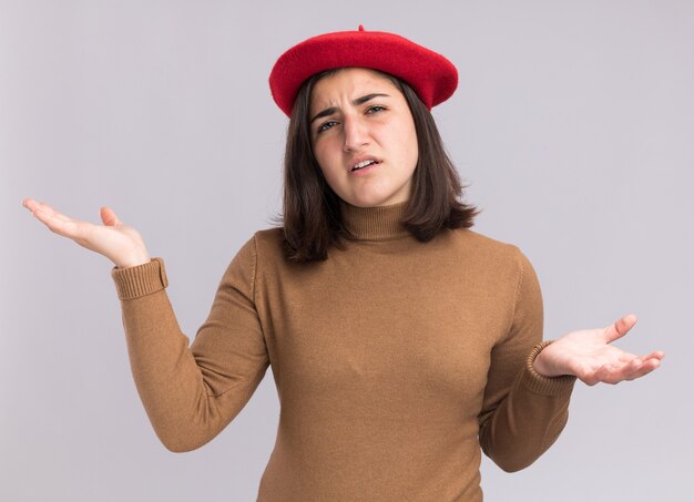 Clueless young pretty caucasian girl with beret hat holding hands open