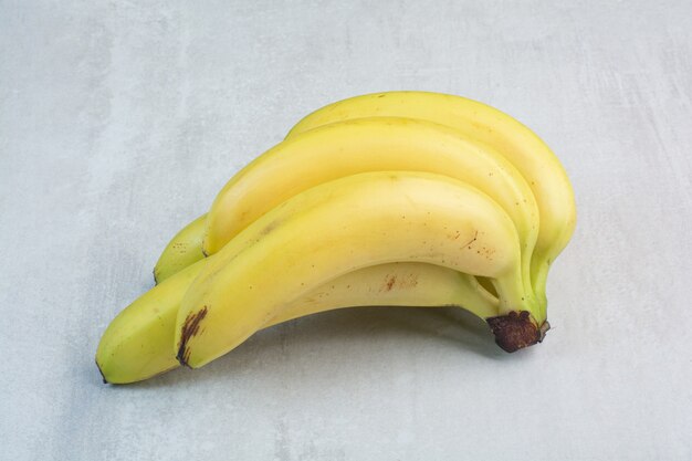 Cluster of bananas on stone background