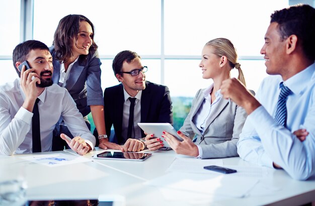 Co-workers planning work with digital tablet