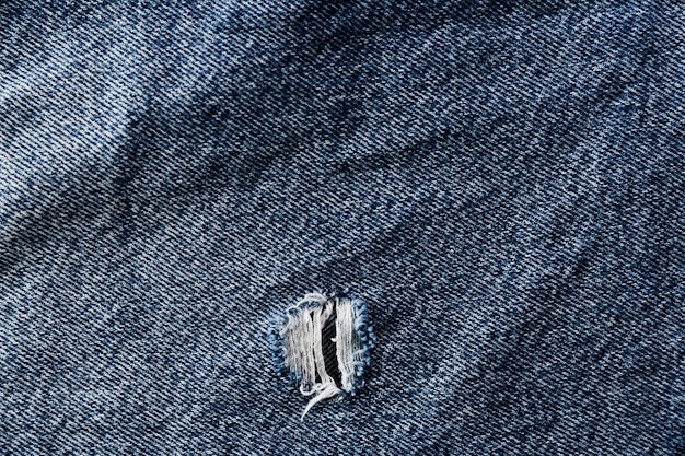 Coarse denim surface with tear