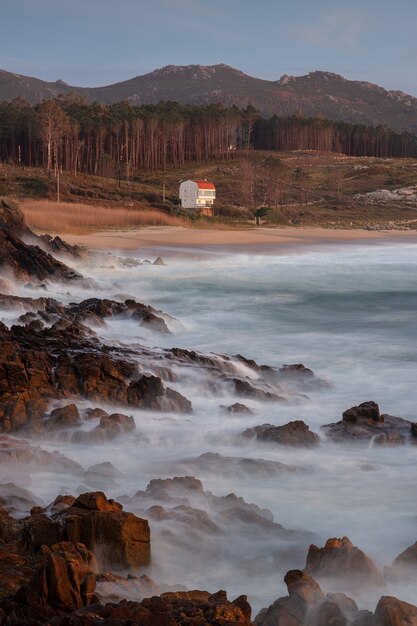 Coastline with stones on the shore during sunset