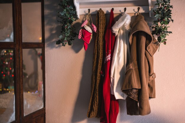 Coat rack with hanging winter clothes