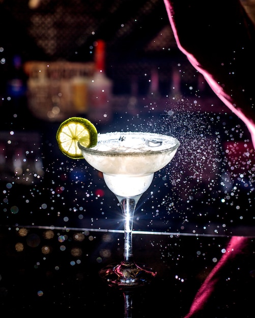 Cocktail decorated with slice of lime