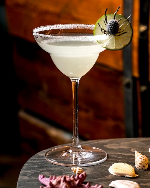 A cocktail glass garnished with salt and lime slice