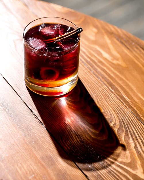 Cocktail glass with ice cubes under the sun light