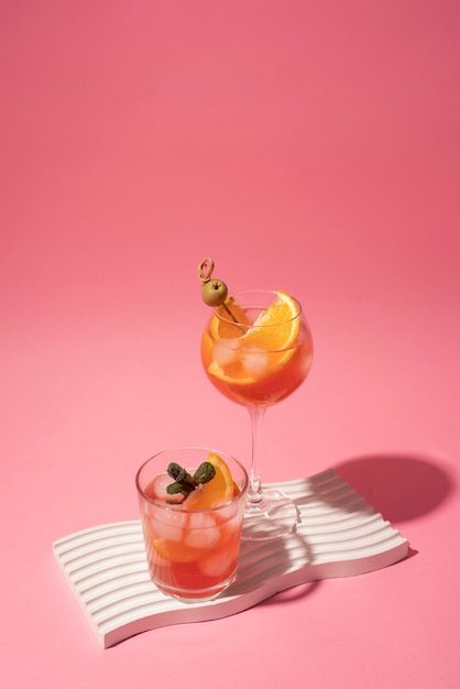 Free photo cocktail glasses with ice cubes and olives