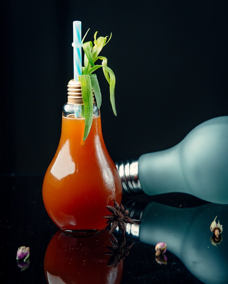 Free Photo cocktail in a lightbulb-shape with leaves