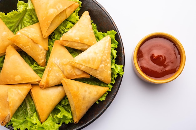 Cocktail mini triangle samosa made using patti or strip, popular home made snack from india