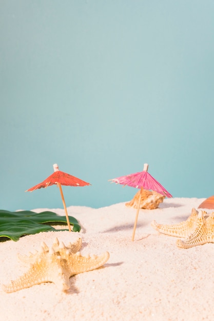 Cocktail umbrellas and starfish on beach