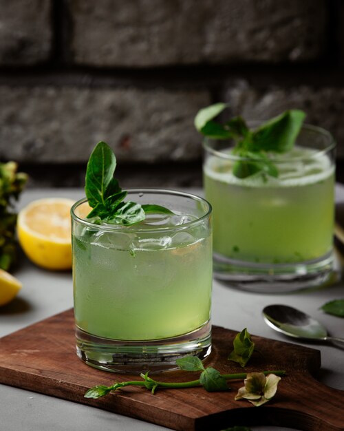 Cocktail with ice cubes and leaves