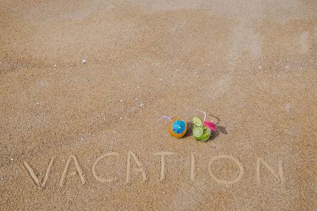 Cocktails and message on sand