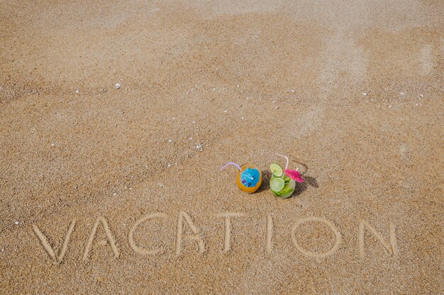 Cocktails and message on sand