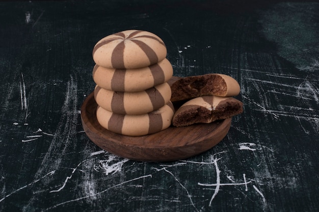 Cocoa biscuit buns in a pile in a wooden platter