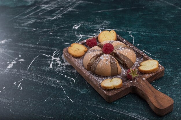 Cocoa and vanilla cookies on a wooden board