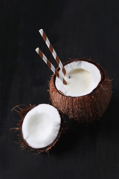 Coconut cocktail with straw. Tropical drink