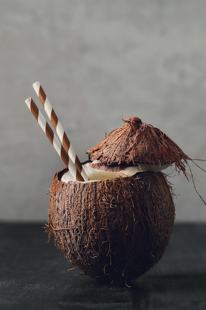 Free photo coconut cocktail with straw. tropical drink