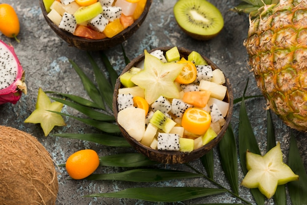 coconut filled with fruit salad and kiwis